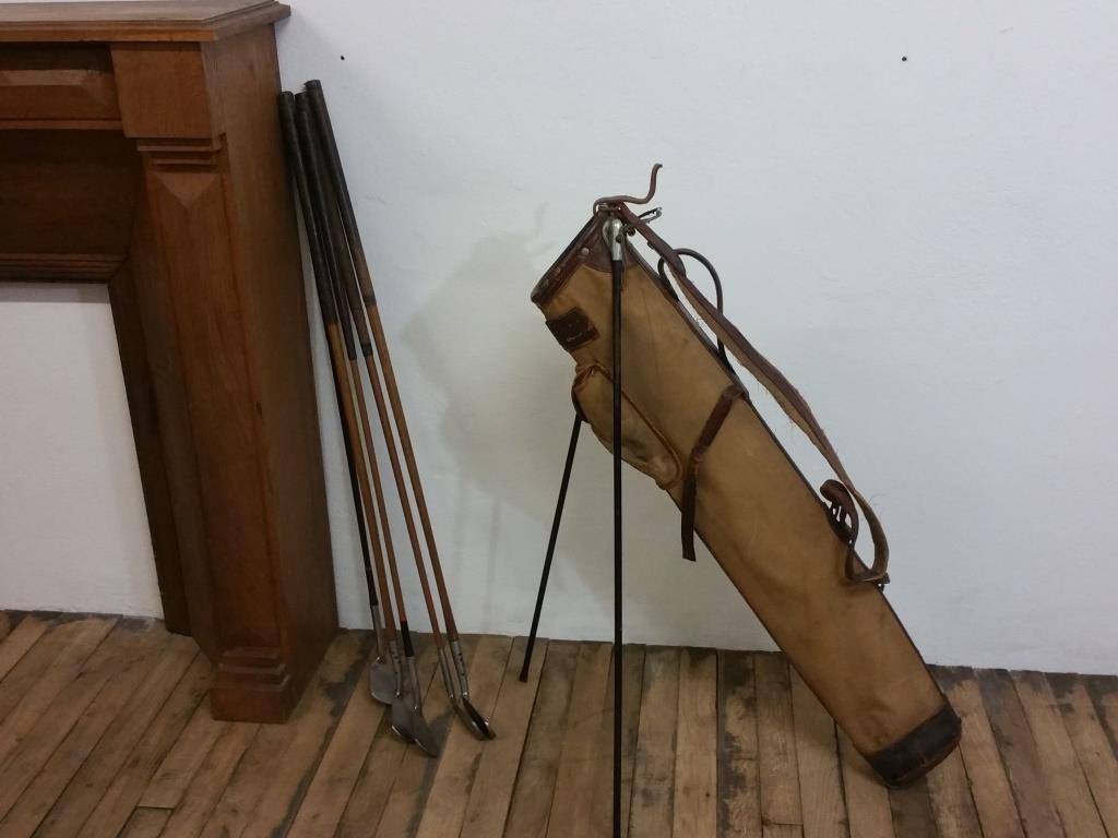 Old golf bag with 5 golf clubs