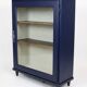 Vintage low glass-fronted library in midnight blue, 1950s.