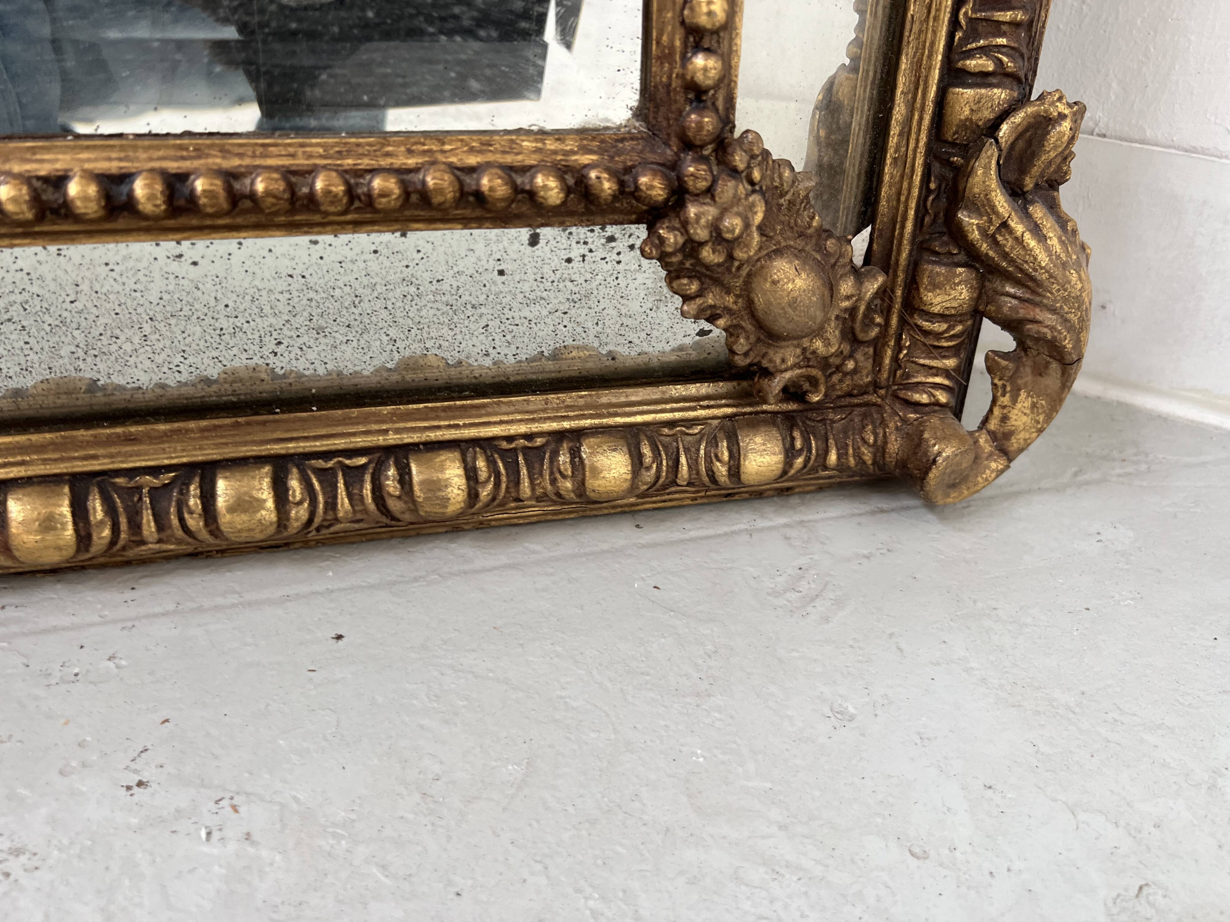Louis XVI style mirror with parecloses in wood and gilded stucco, 19th century