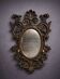 Antique Louis XV style mirror, richly carved with decorations of scrolls, shells, and foliage.