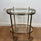 Small wheeled table in silvered brass from the Baguès house.