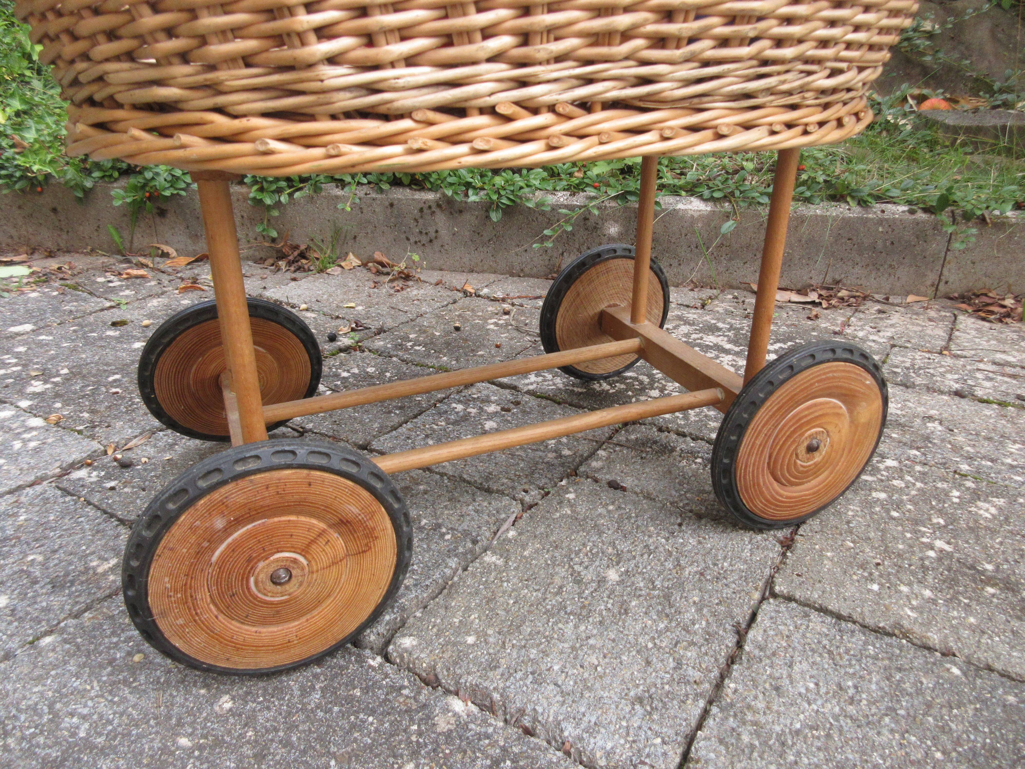 Doll cradle on wicker wheels
