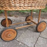 Doll cradle on wicker wheels