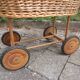 Doll cradle on wicker wheels