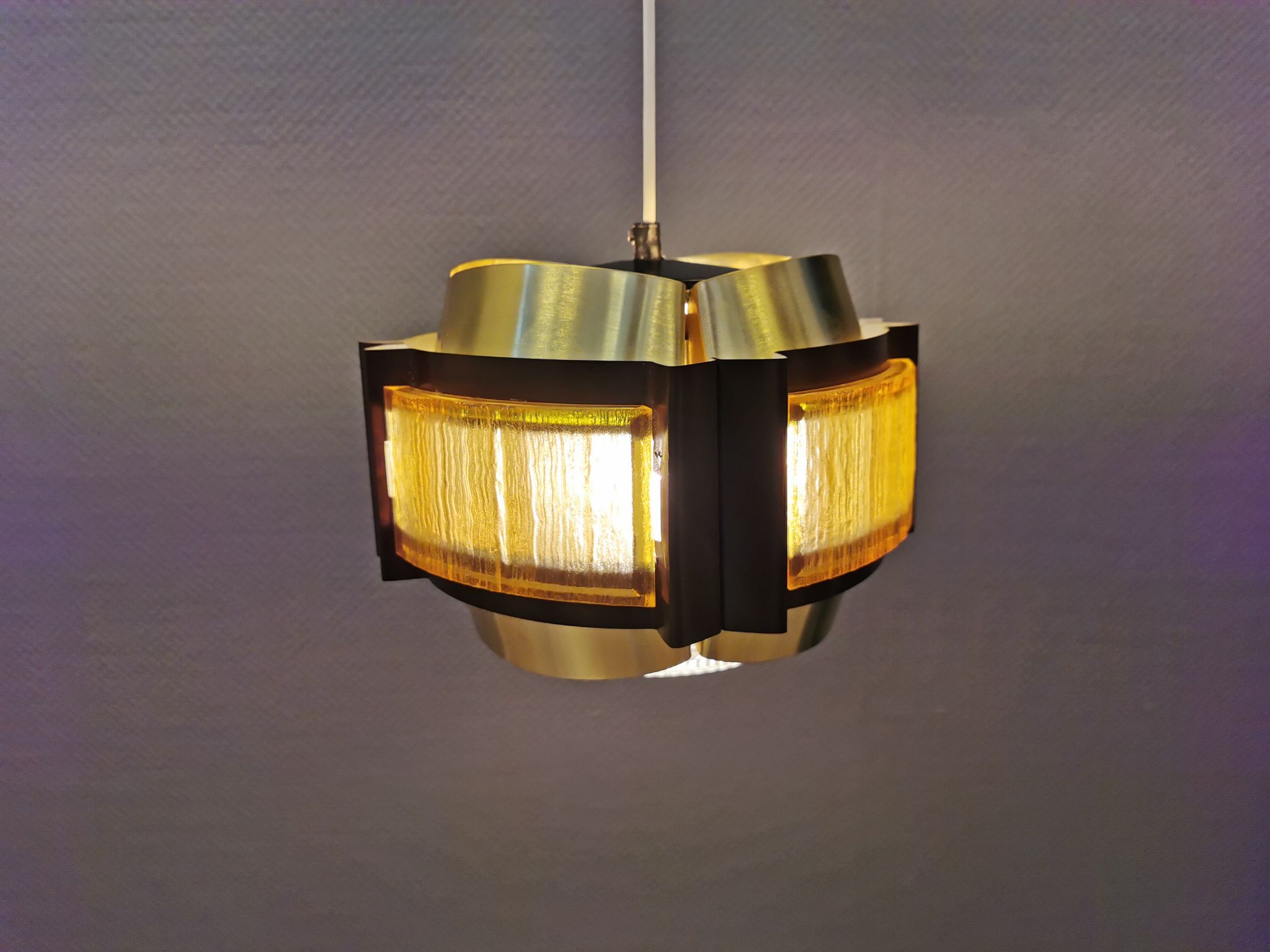 Danish hanging lamp, made in brass colored and brown metal, with yellowish hard pressed plastic deta