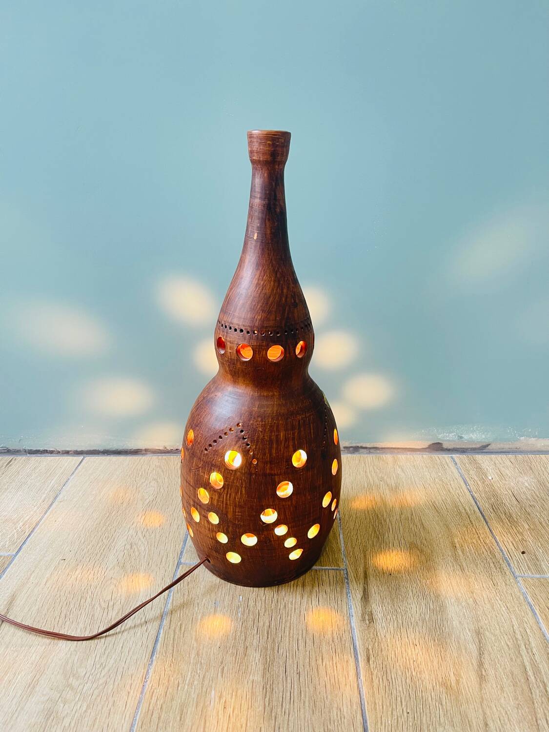 Terracotta lamp with cut-outs, circa 1970.