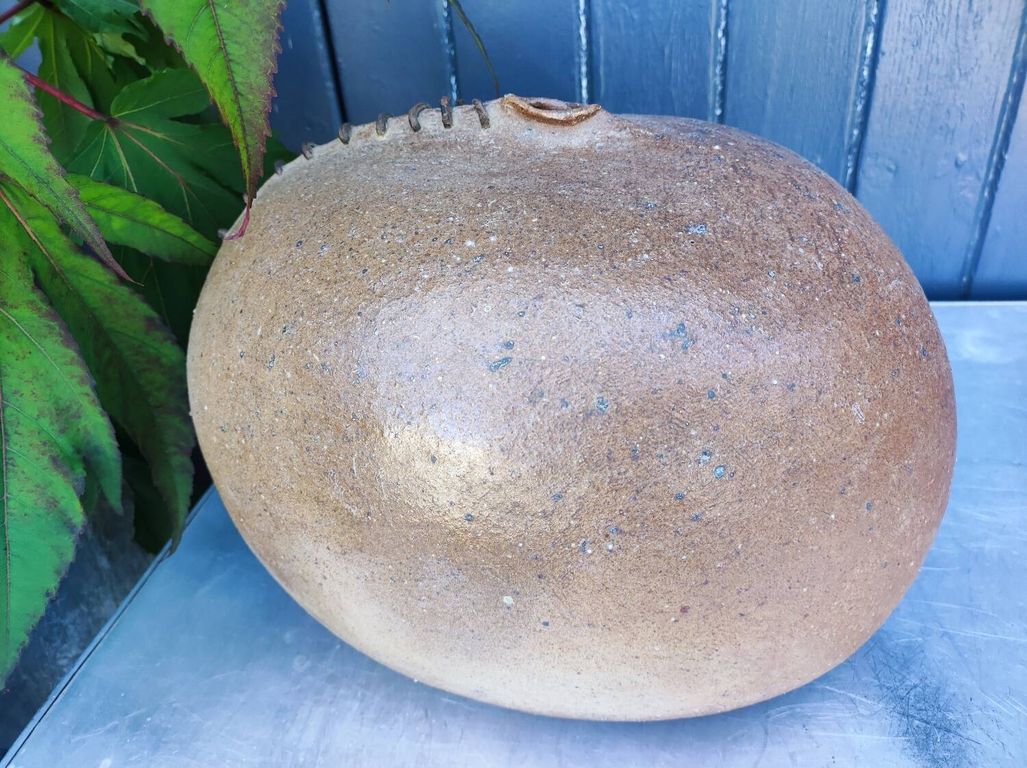 Vintage sandstone vase, in the shape of a rugby ball, signed