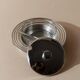 Vintage 1970s condiment pot made of glass and stainless steel with a lid, complete with a matching spoon.