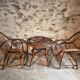 Vintage rattan lounge set, French wicker armchairs and round table, circa 1930–1950.