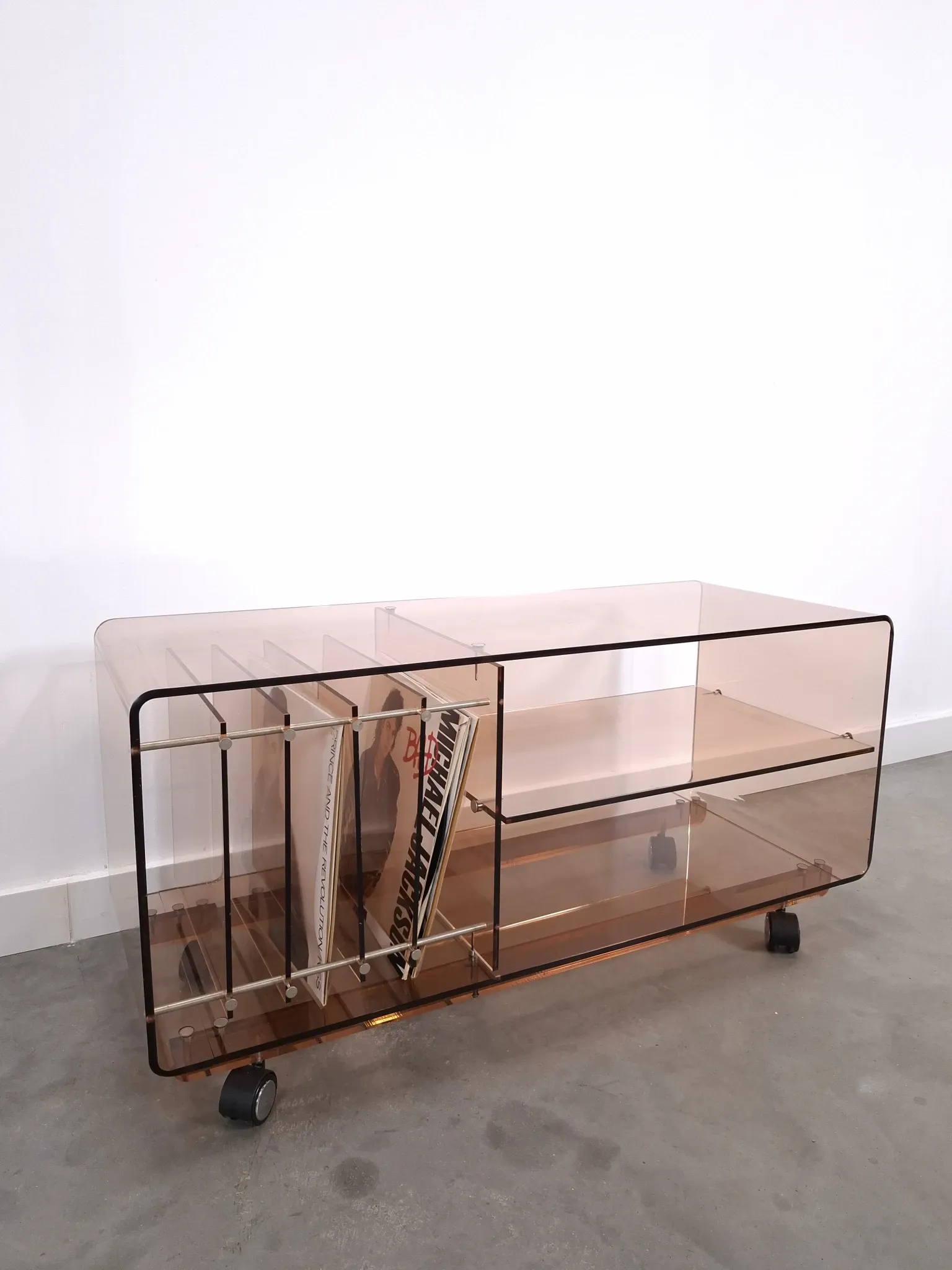 Vintage hifi, LP cabinet, TV unit made of tinted plexiglass on wheels, records.