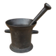Ancient large mortar and pestle of a black cast iron apothecary.
