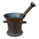 Ancient large mortar and pestle of a black cast iron apothecary.