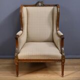 Wingback armchair in walnut, Louis XVI style – late 19th century