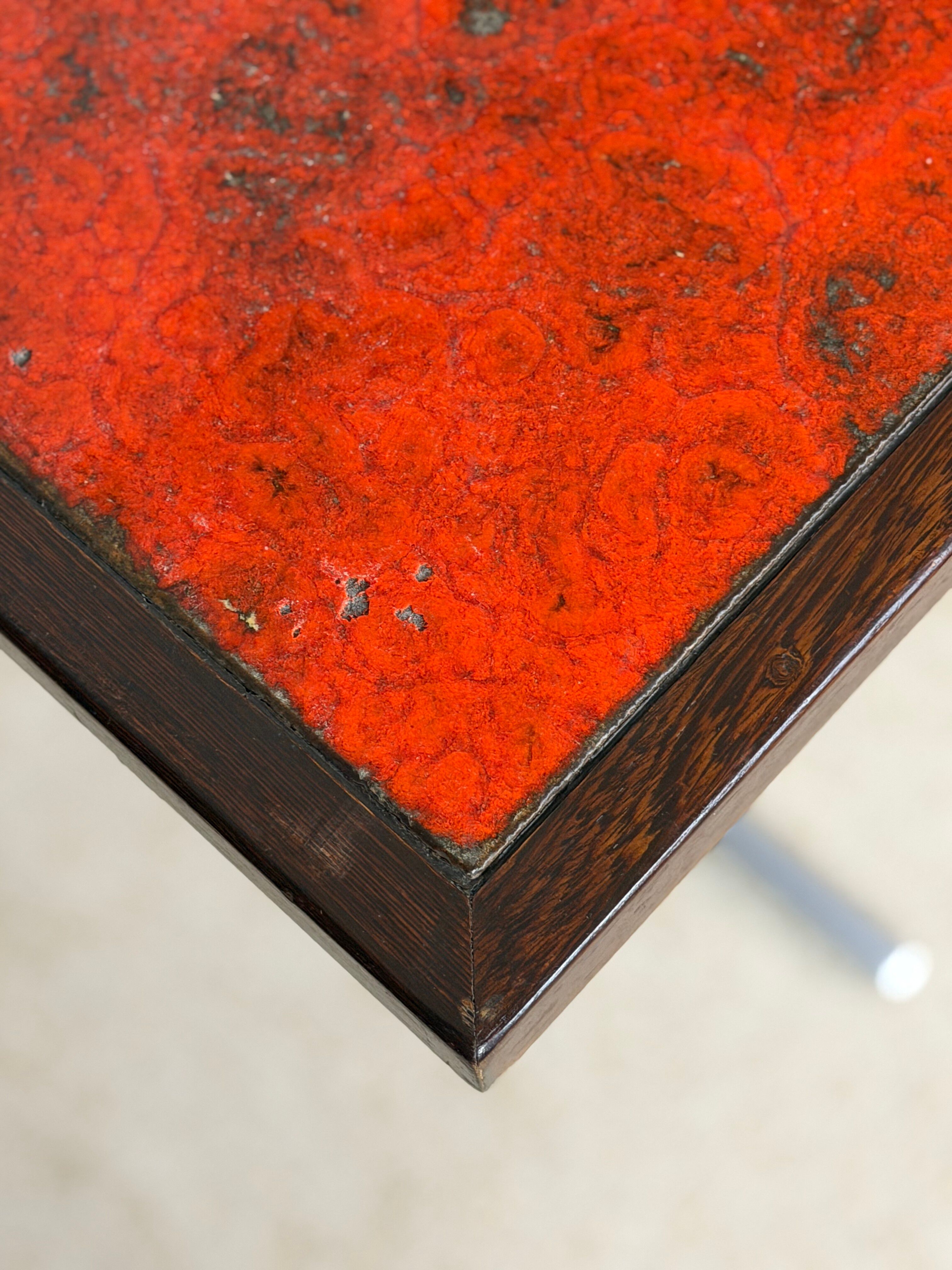 Vintage bistro table with orange-red ceramic.