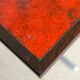 Vintage bistro table with orange-red ceramic.