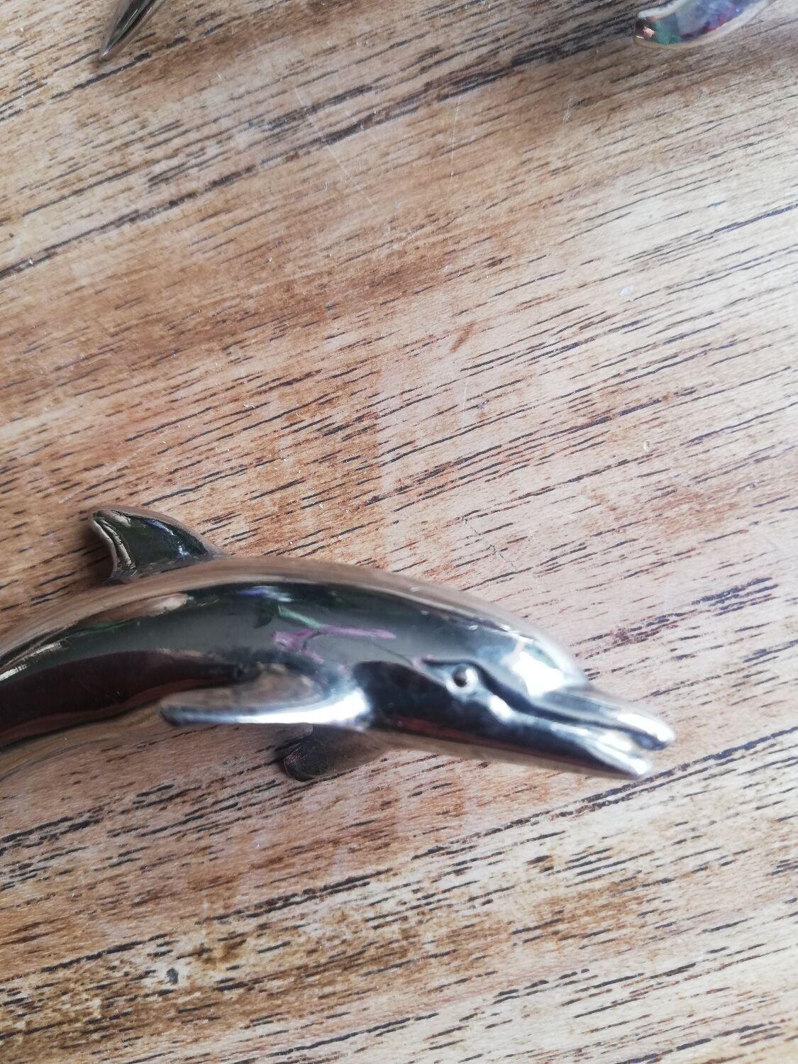 Set of three silver metal dolphin place markers