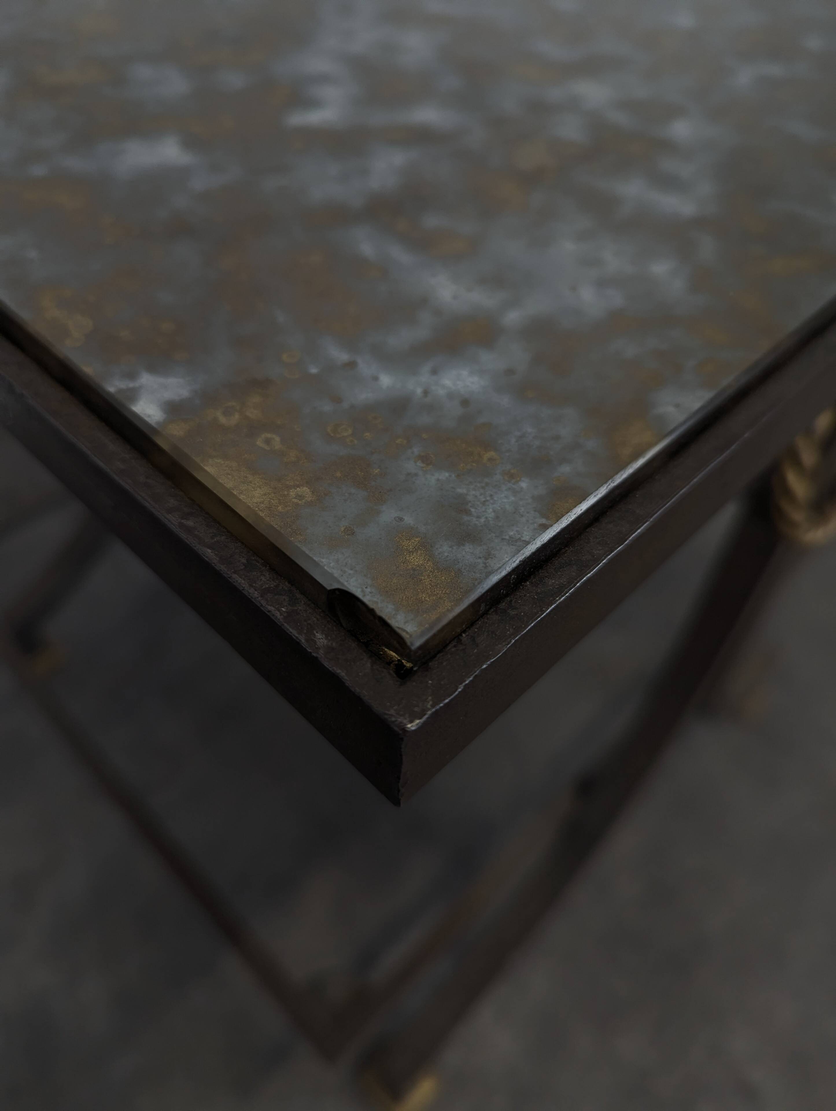 Neoclassical side table in wrought iron and eglomisé glass.