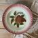 Antique shallow dish in slipware with pear decoration.