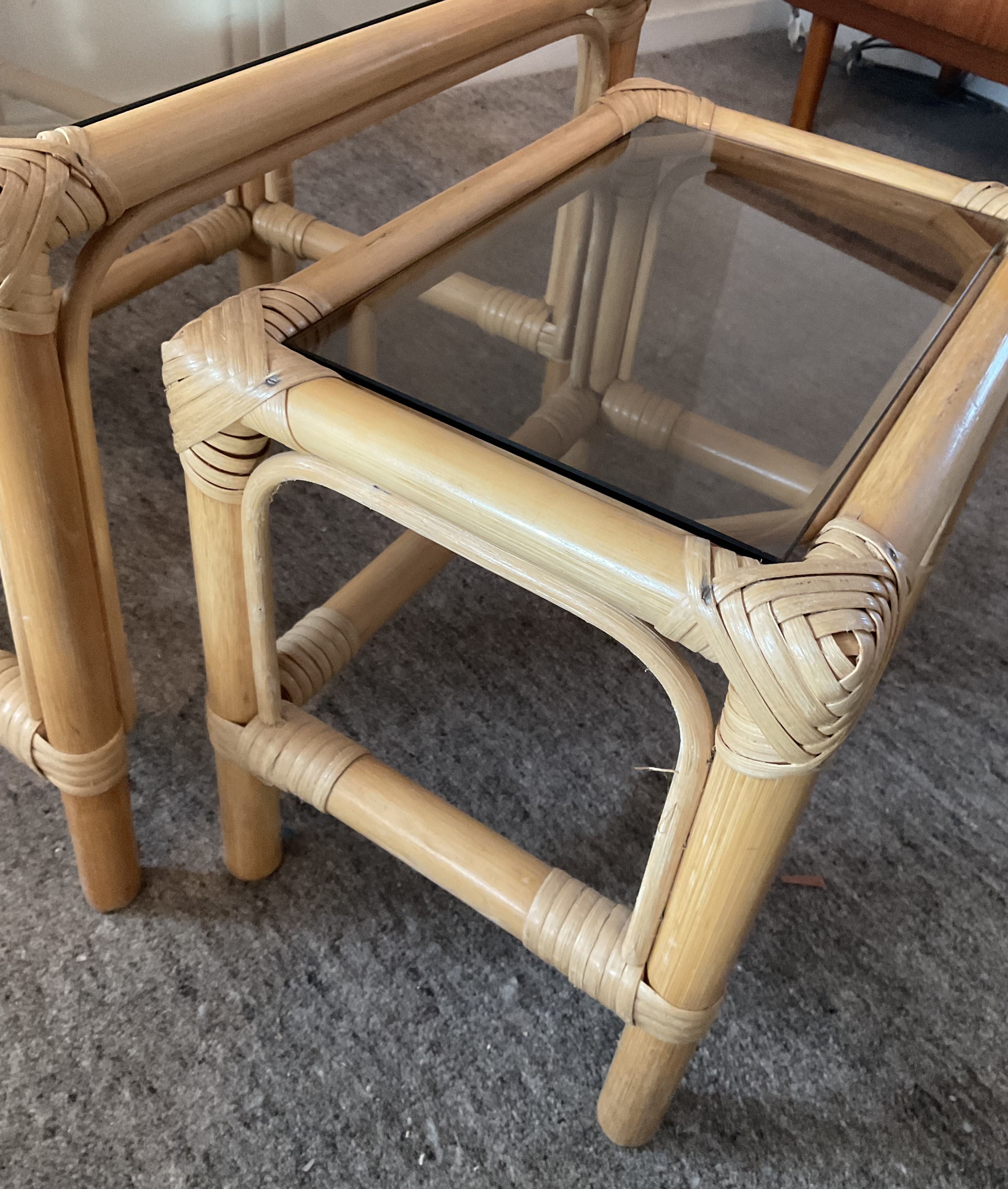 Trio of vintage pull-out tables in rattan and smoked glass 70s