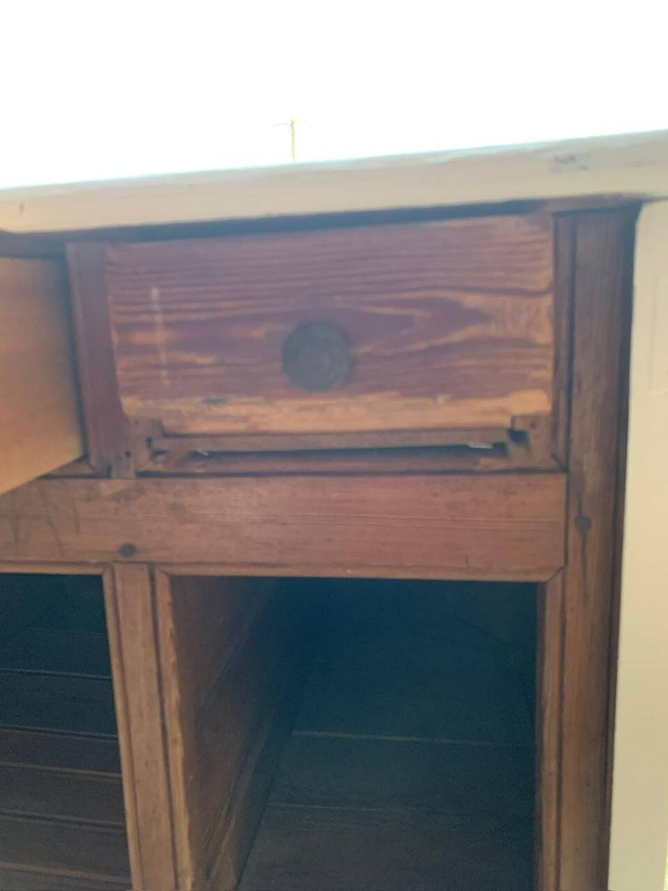 White counter with brass coin mechanism