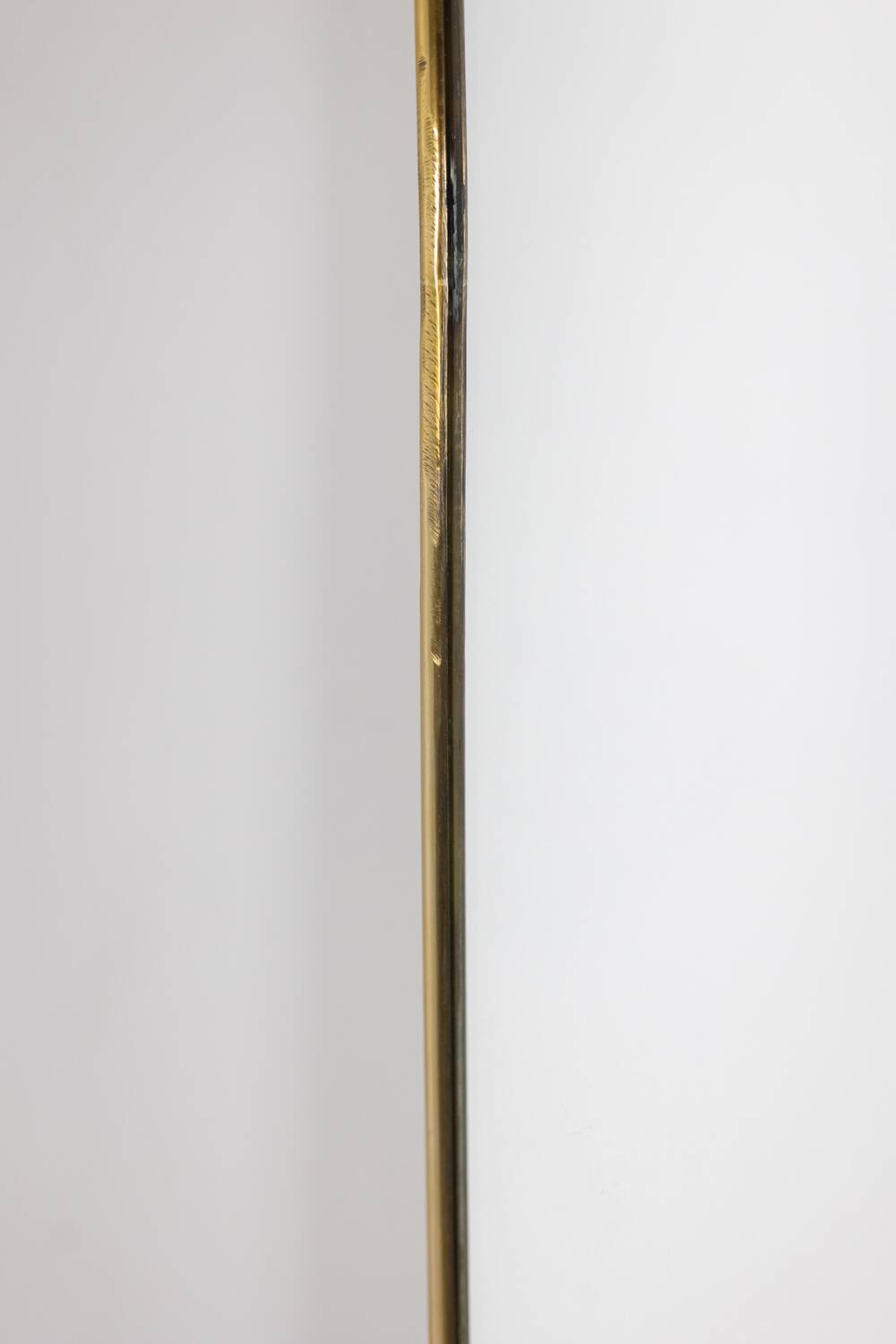 Pair of narrow gilt brass mirrors. Circa 1970.