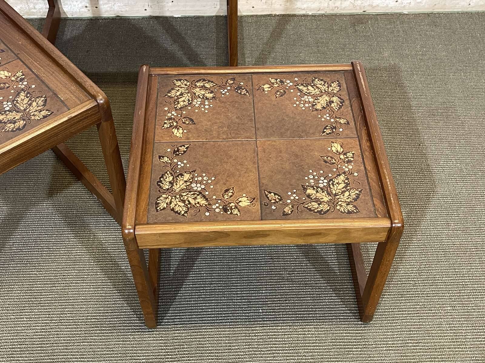 Set of 3 nesting tables in teak with tiled tops.