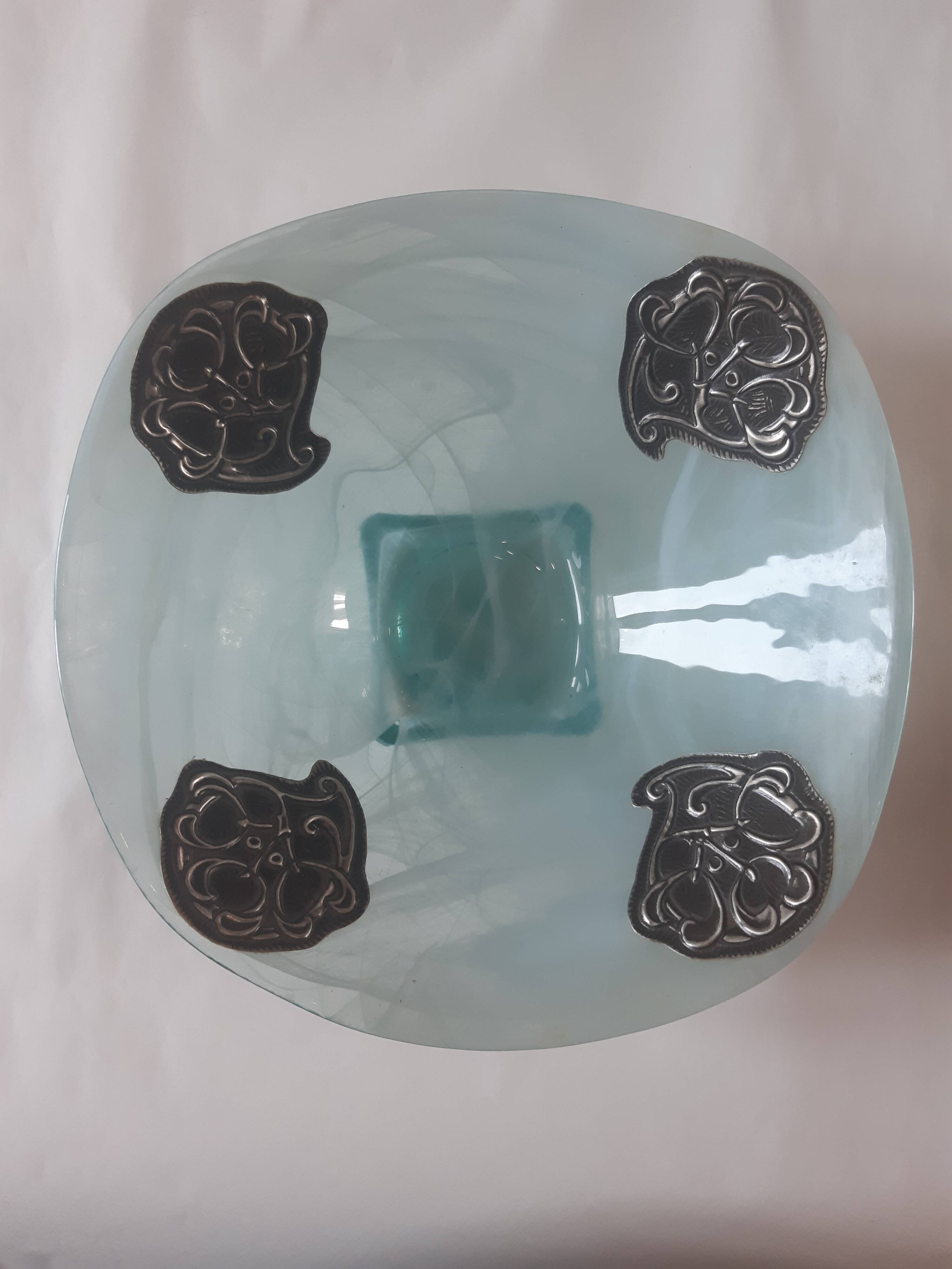 Handcrafted glass fruit bowl with ribbed design set with pewter medallions.