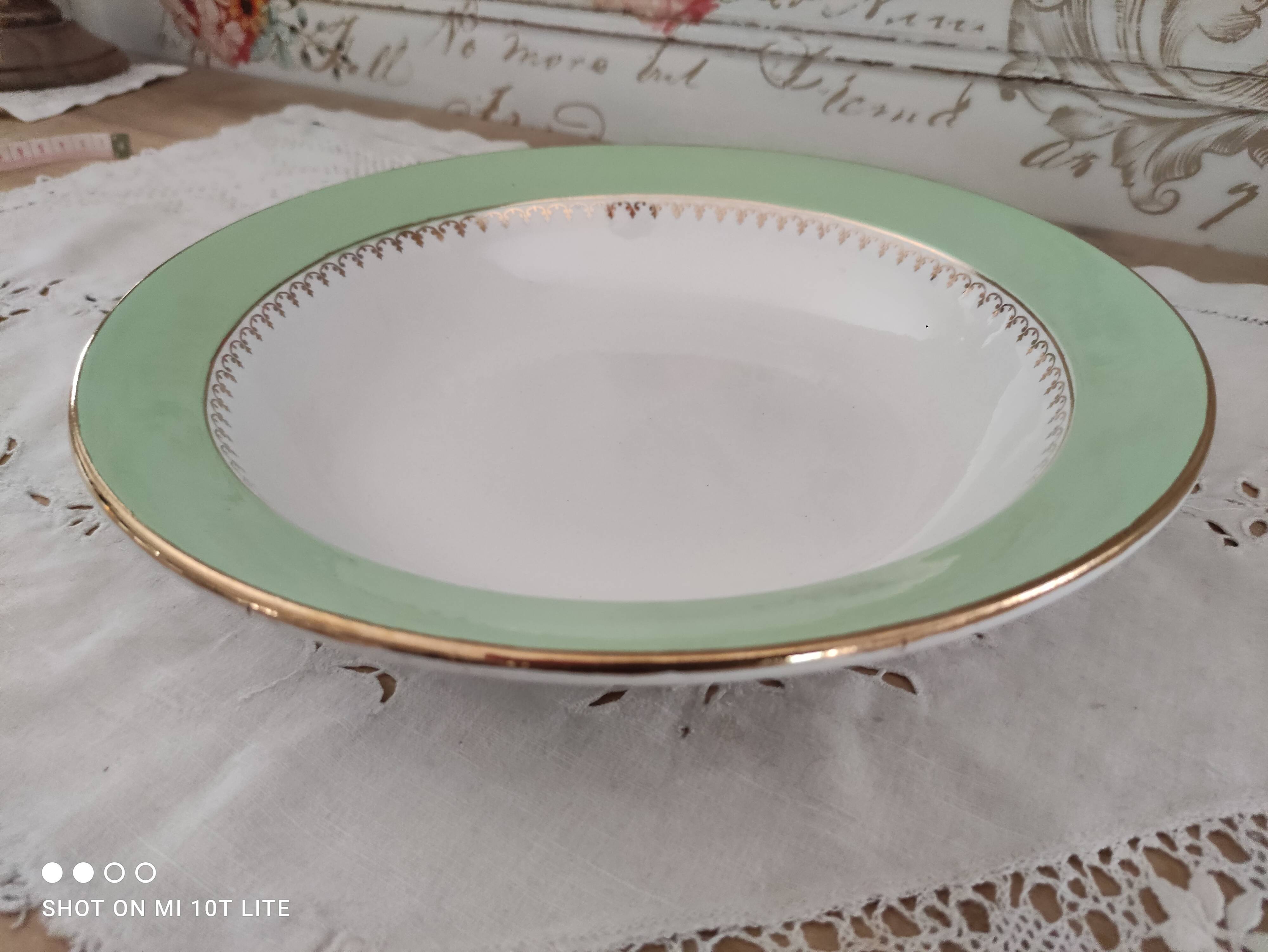 Round hollow plate in water green with a golden frieze, Cafés Lemaire.