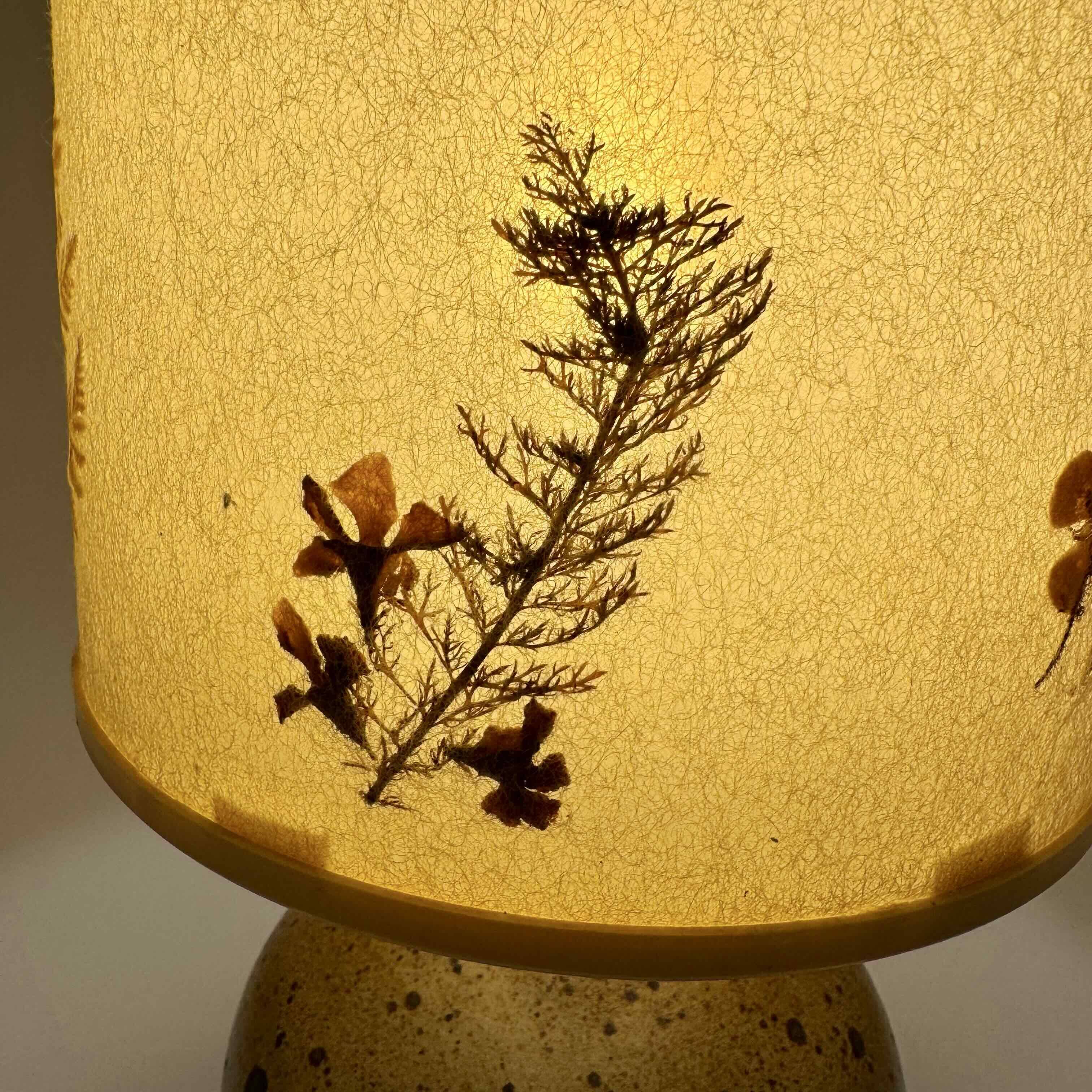 Pyrite stone ball lamp with a lampshade featuring dried flower inclusions.