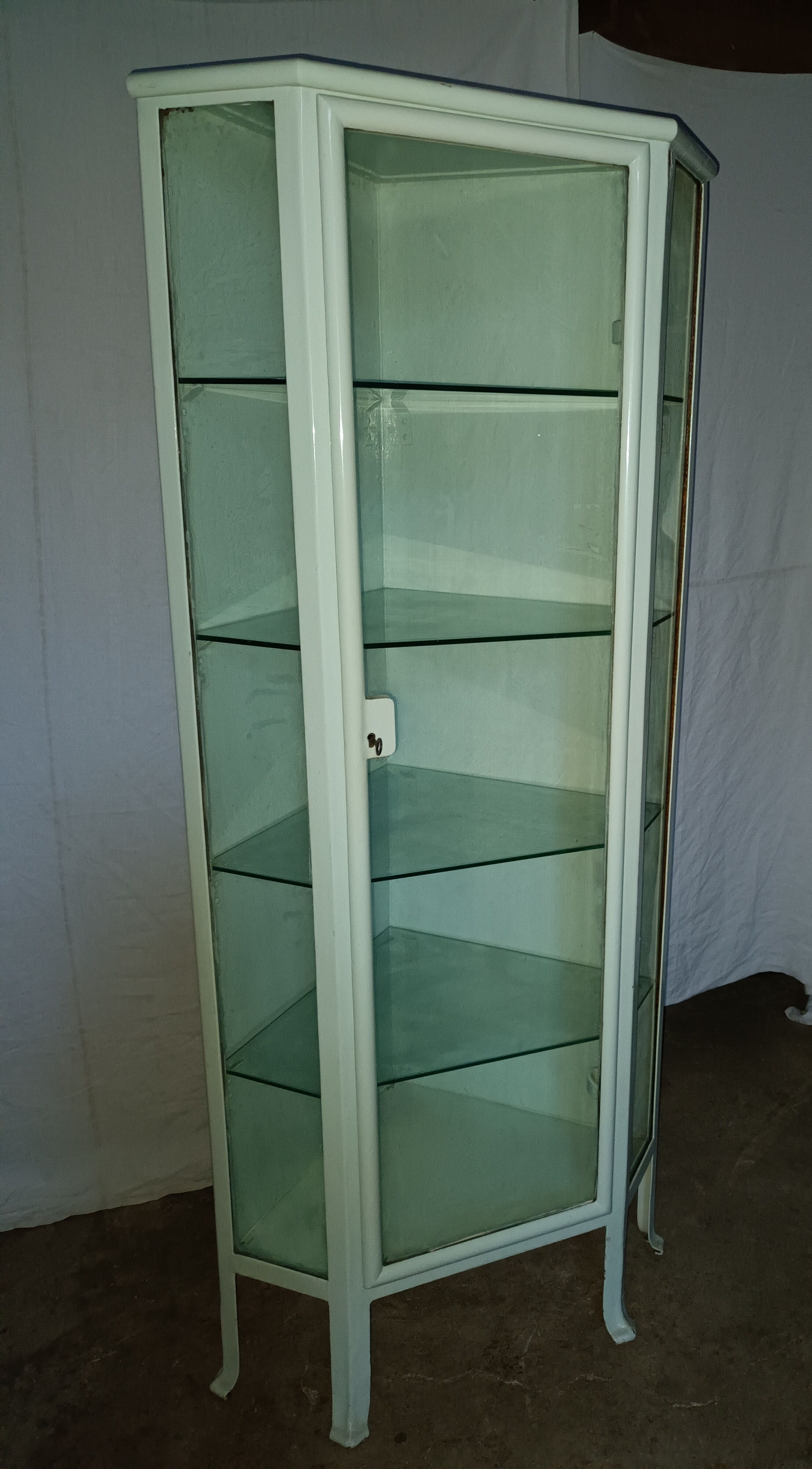 Painted metal ophthalmologist's corner display case, early 20th century