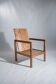 Large armchair in natural wood (teak) with a minimalist design.