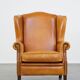 Cow leather wingback chair finished with decorative nails
