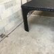 large industrial table in graphite black riveted metal