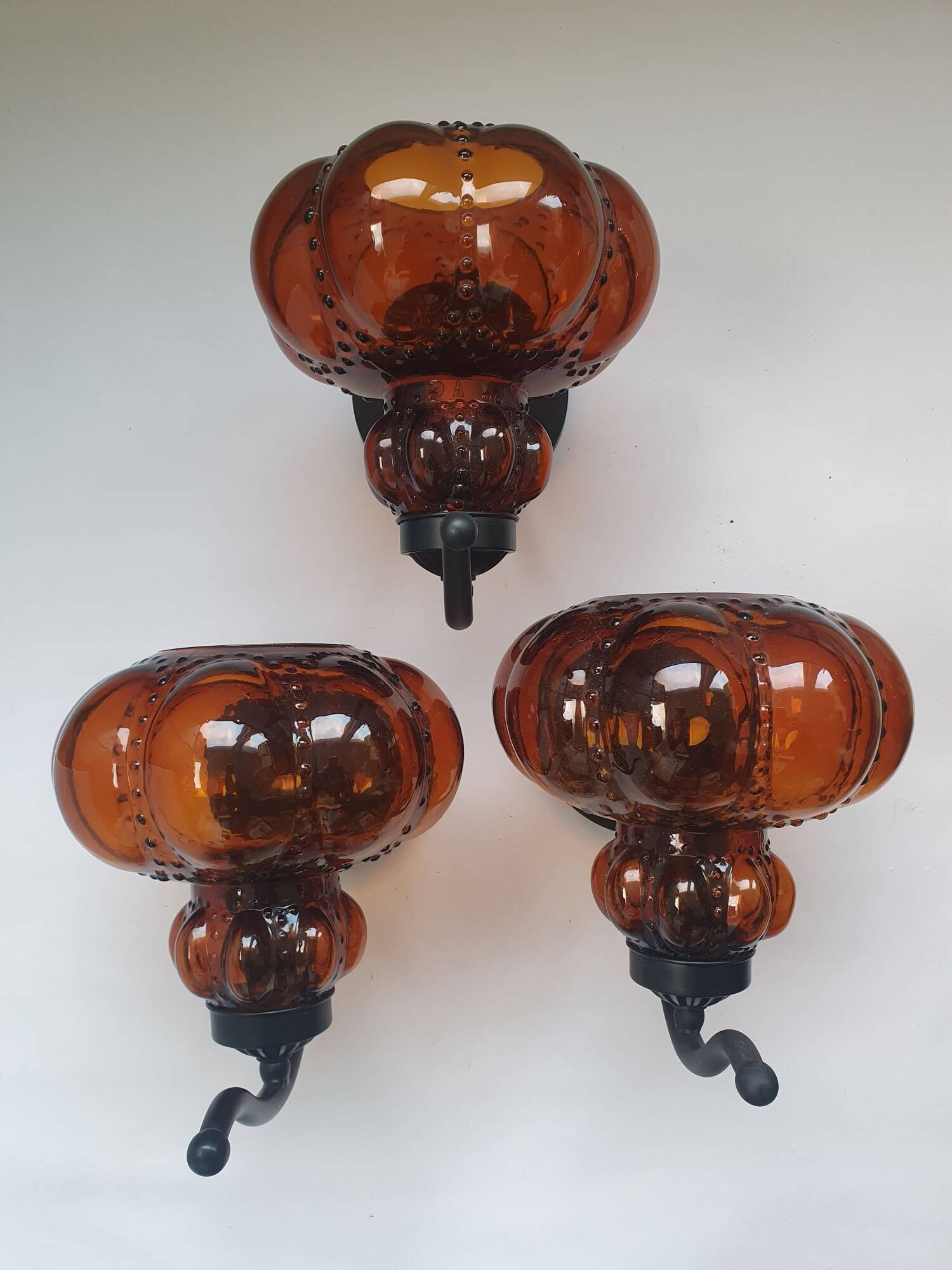 Three large vintage brown glass wall lights
