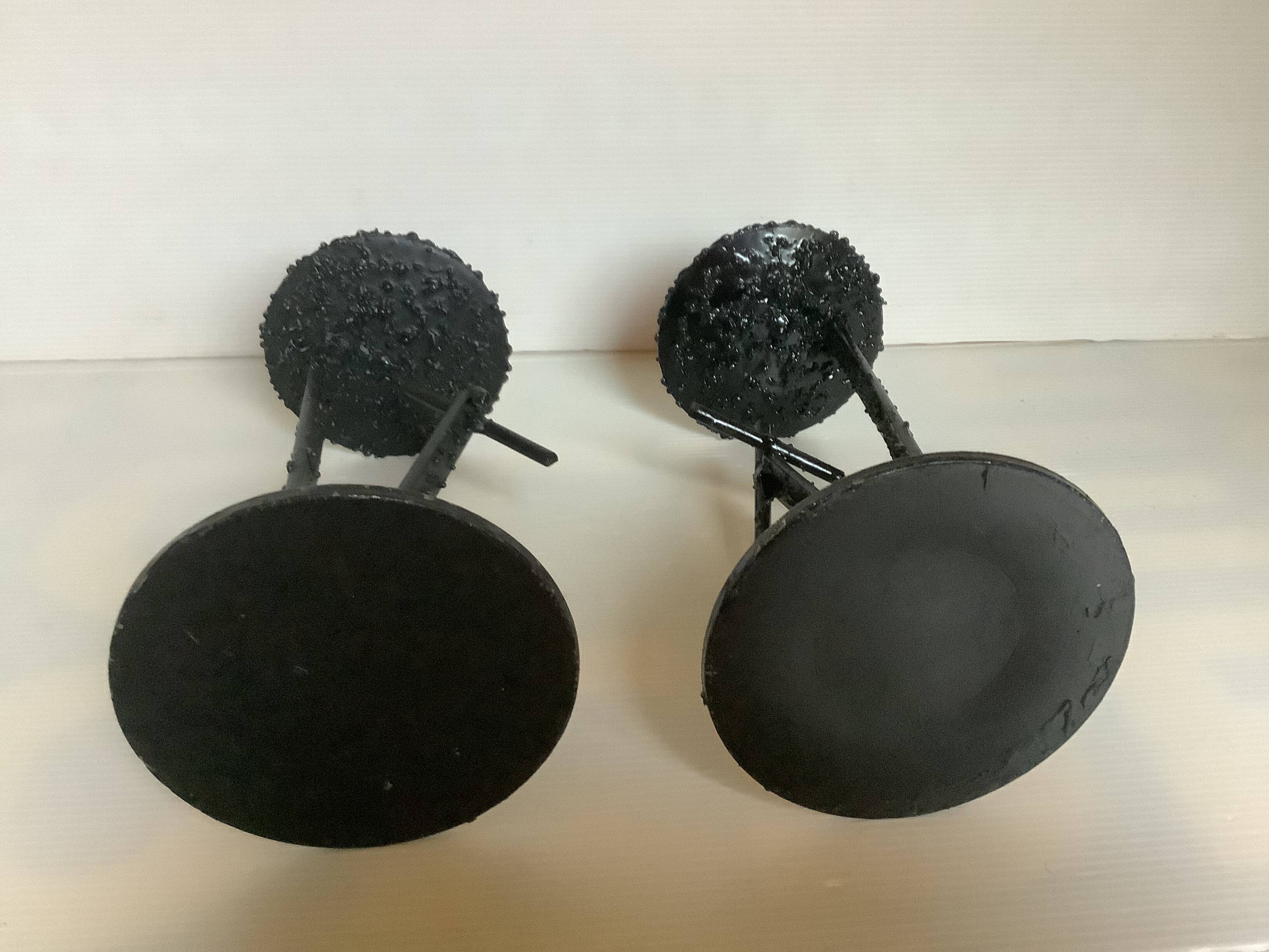 Pair of black metal candlesticks