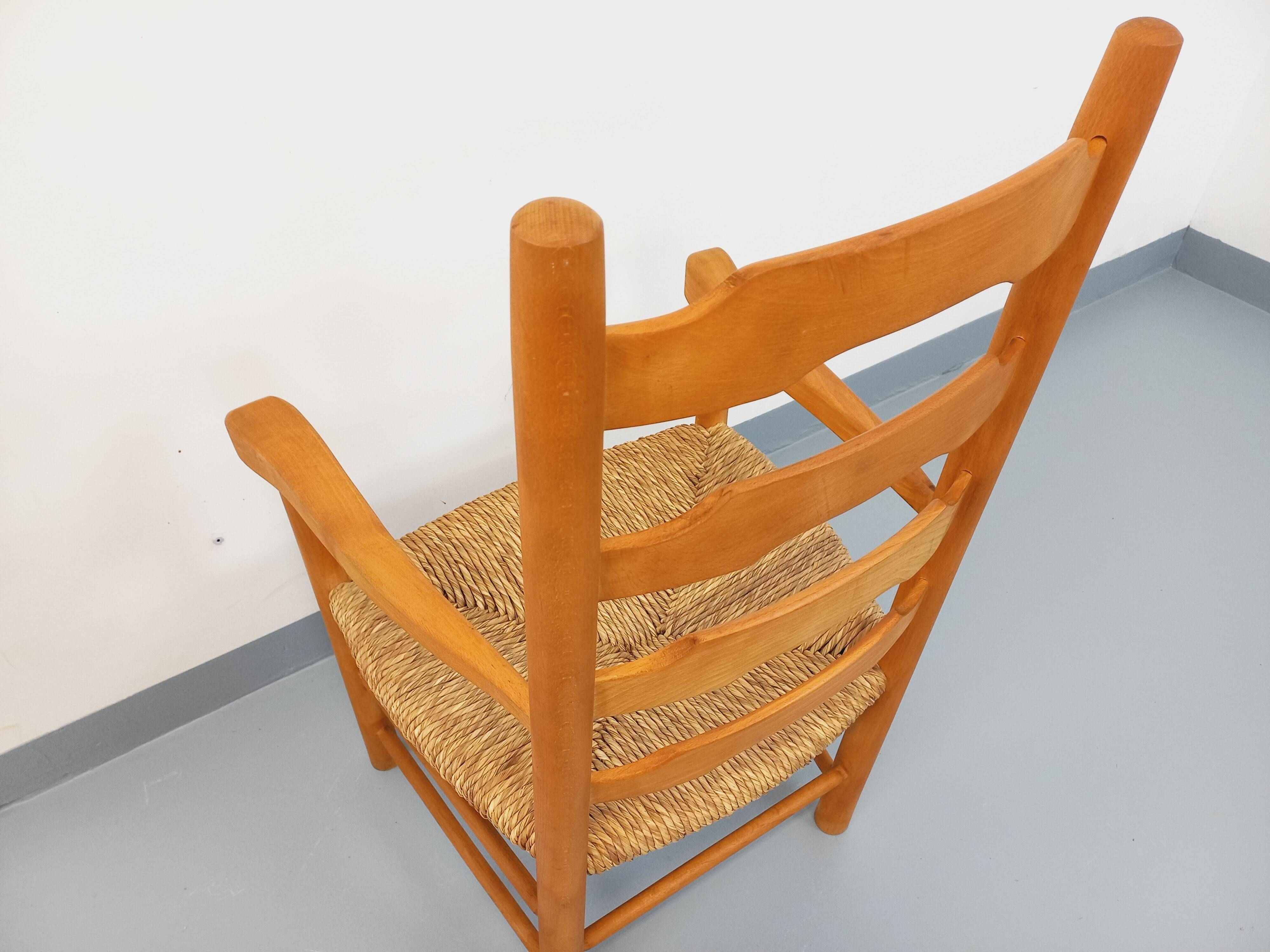 Vintage armchair in beech wood and straw from the 1950s.