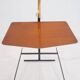Brass and lacquered metal floor lamp with a wooden magazine shelf.