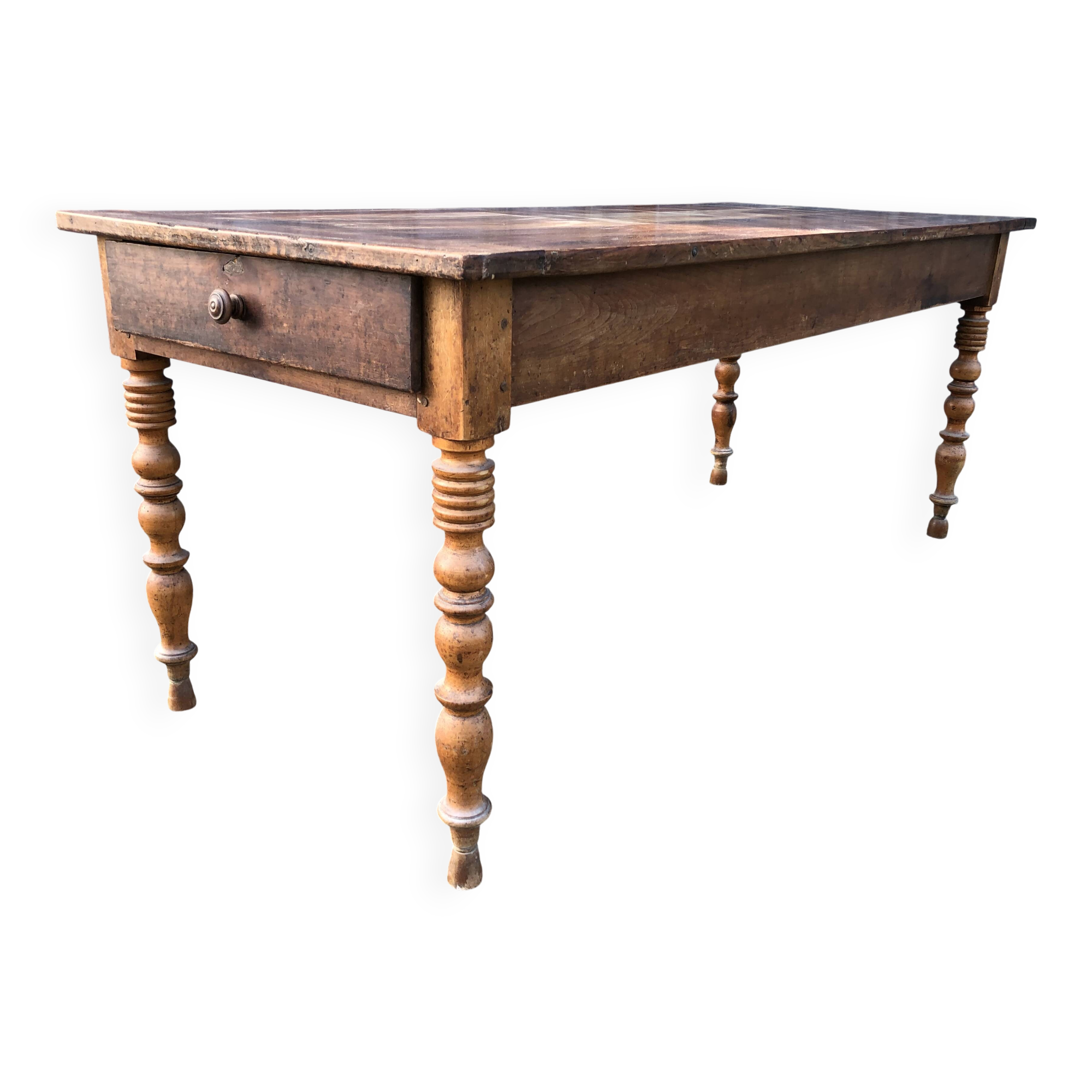 Antique farmhouse table in solid cherry wood with turned legs.