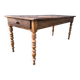 Antique farmhouse table in solid cherry wood with turned legs.