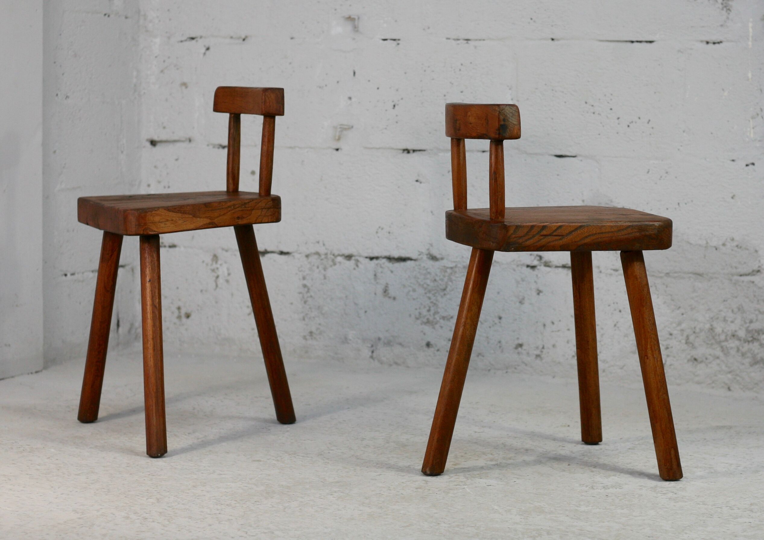 Pair of tripod stools with brutalist backrests, France, circa 1960