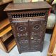 Small antique side table in carved wood.