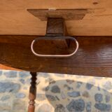 Round console table with folding shutters on copper wheels