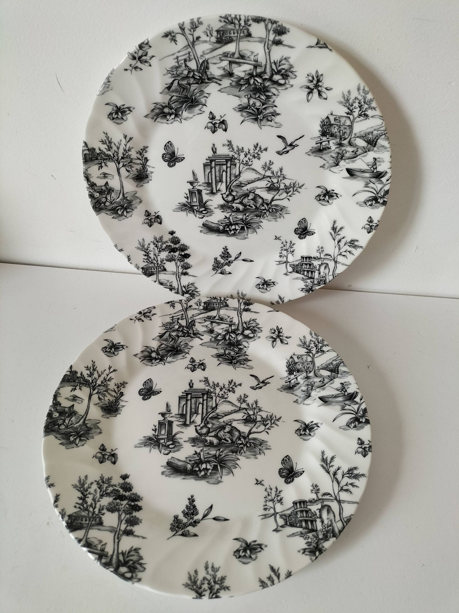 Set of black and white plates in the style of toile de Jouy.