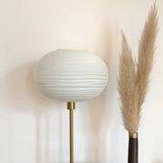 Table lamp made with an old globe in streaked white glass and a golden foot