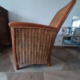 Armchair in woven rattan and exotic wood