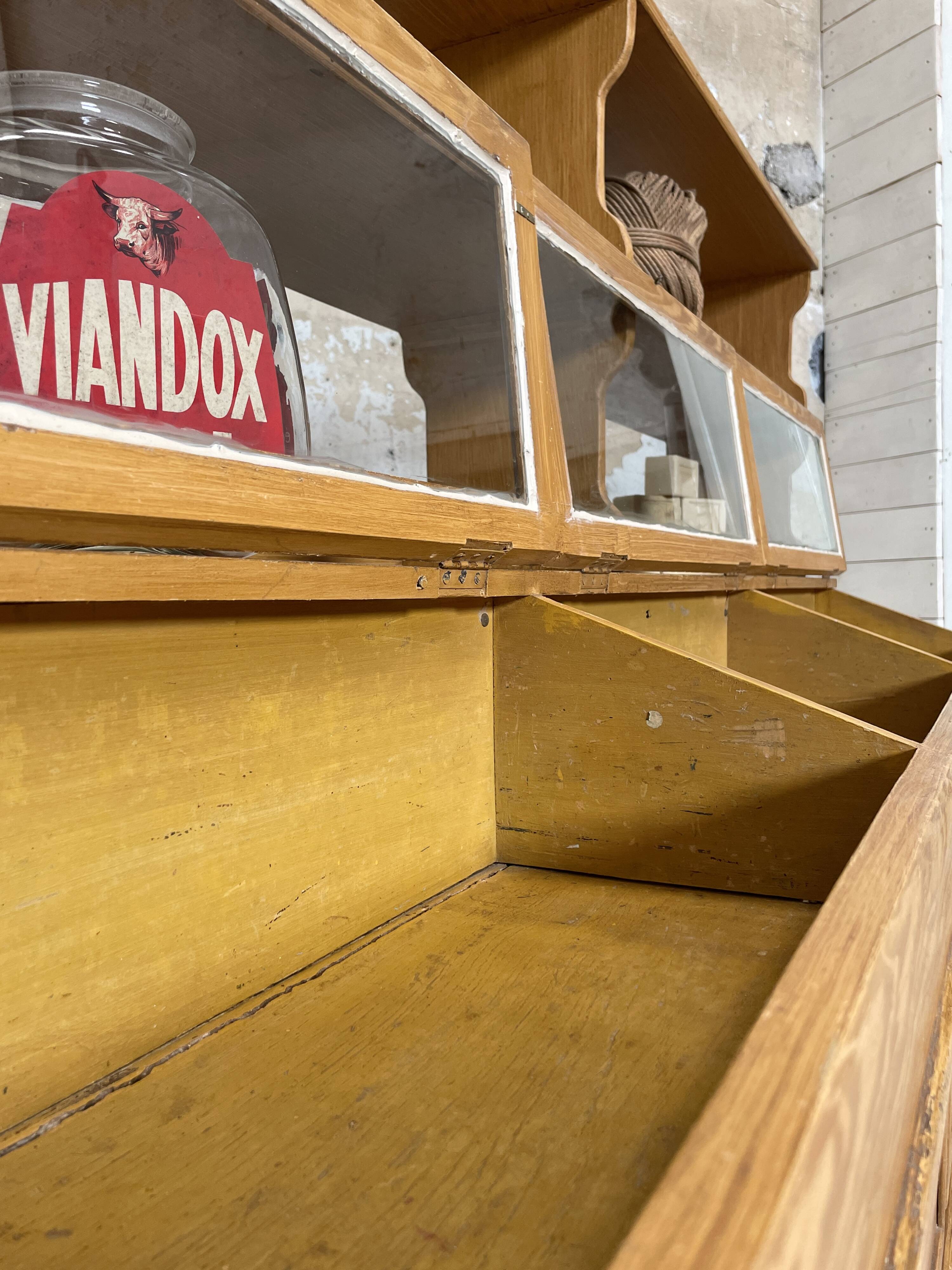 Wooden hardware cabinet painted with wood effect, circa 1940.