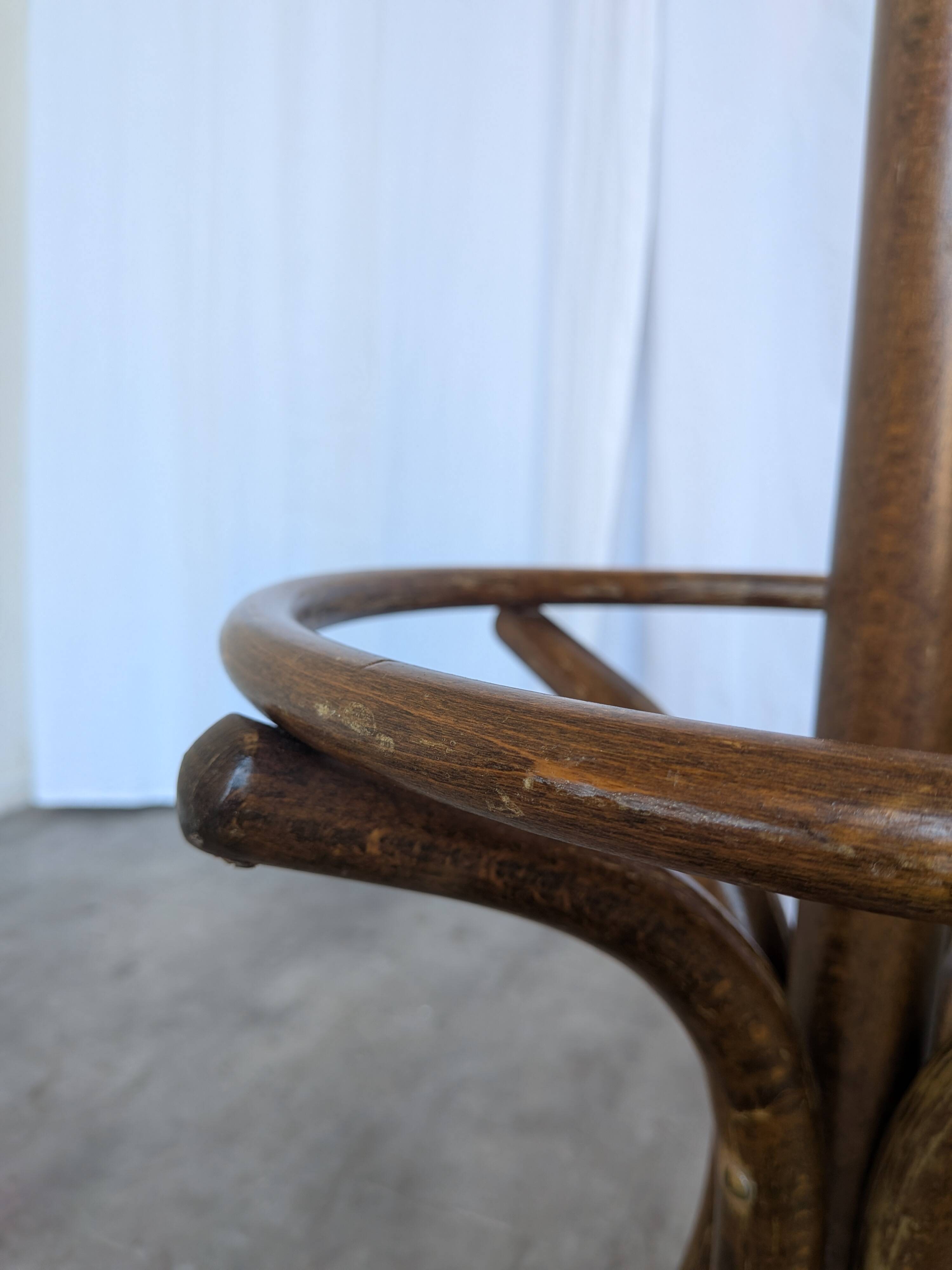 Vintage bentwood coat rack in Thonet style / Dark wood coat rack with shadow.