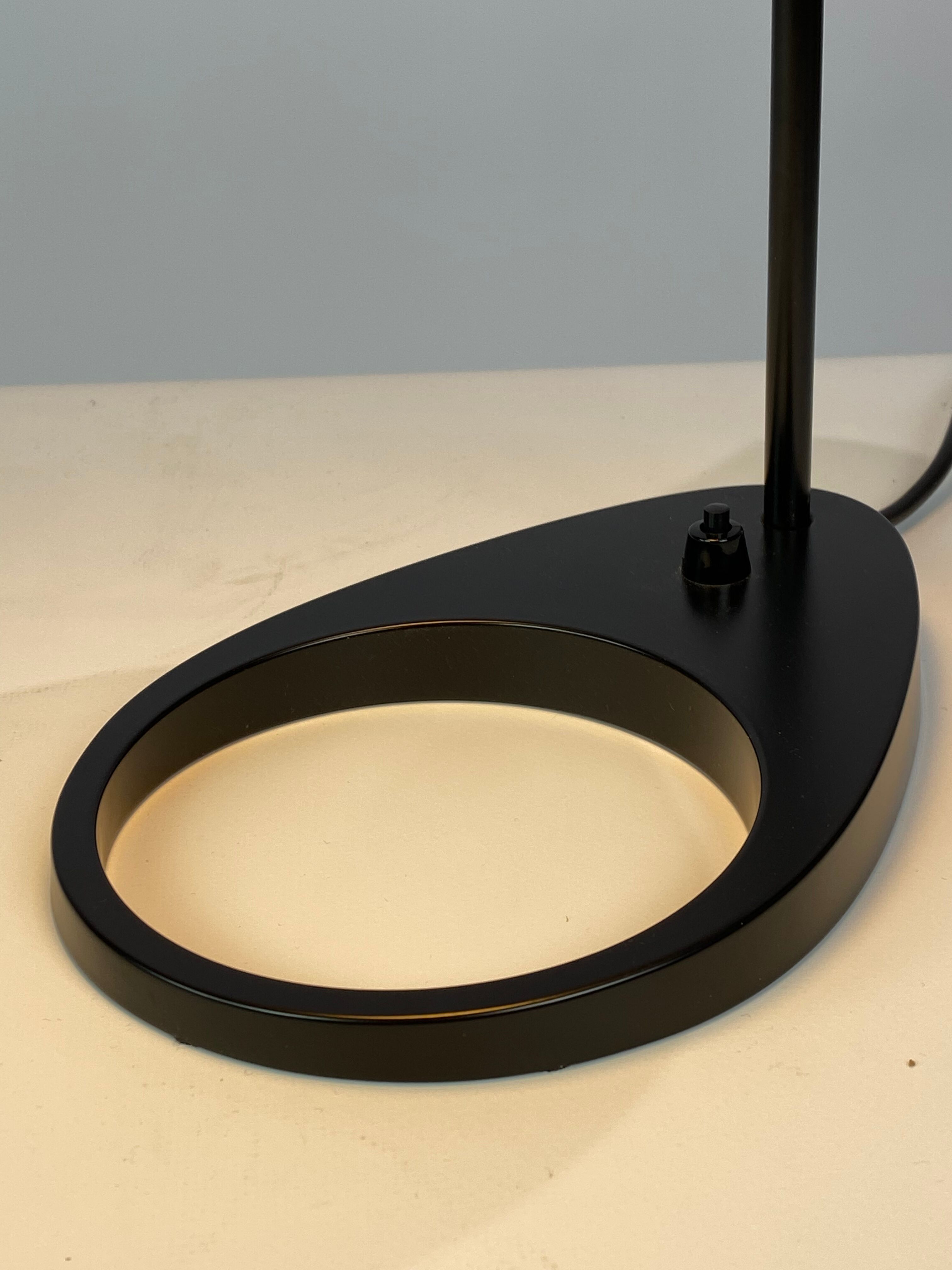 Black table lamp designed by Arne Jacobsen and manufactured by Louis Poulsen
