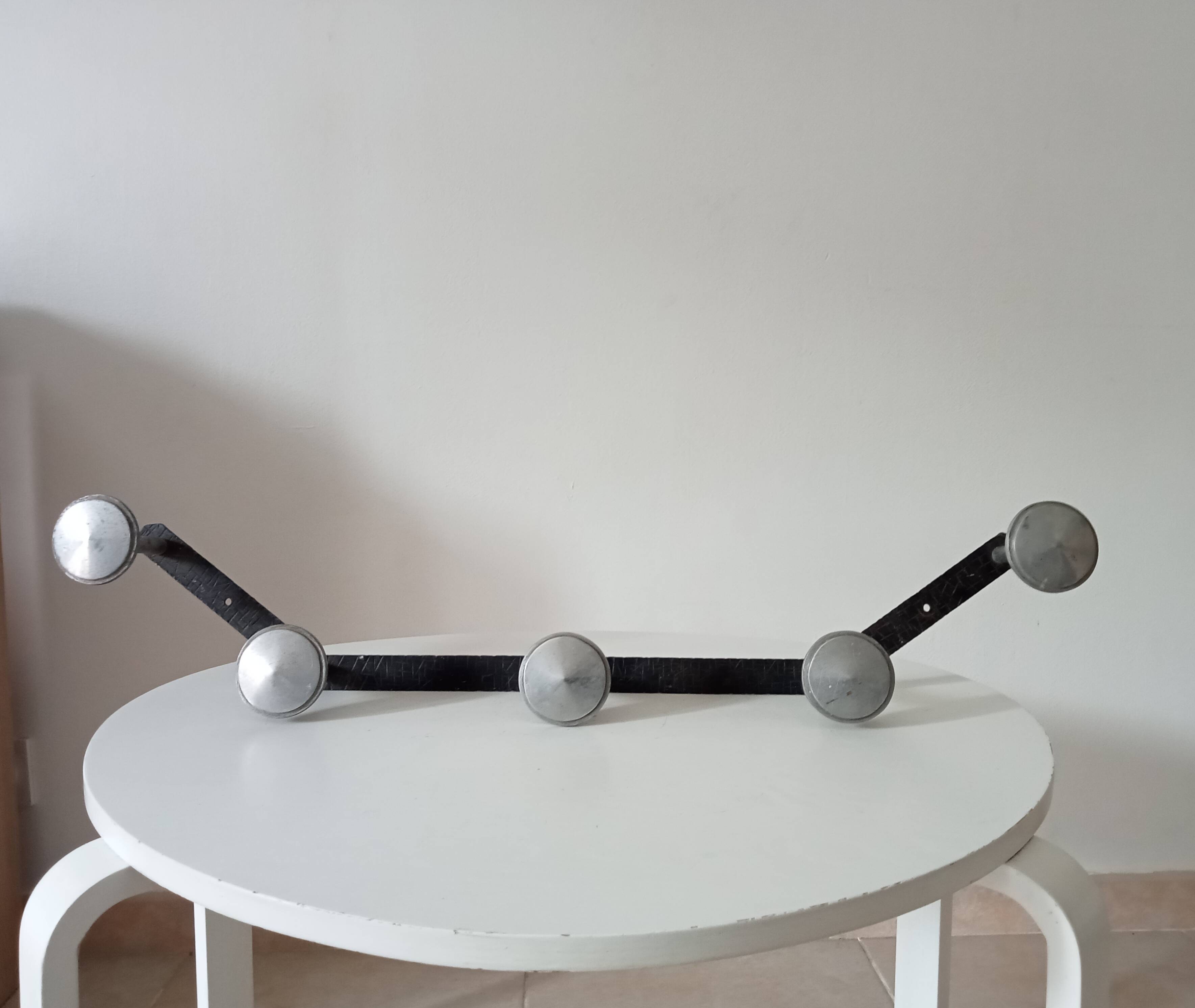 Vintage 1950s wall coat rack, wrought iron with chiselled details and solid aluminium.