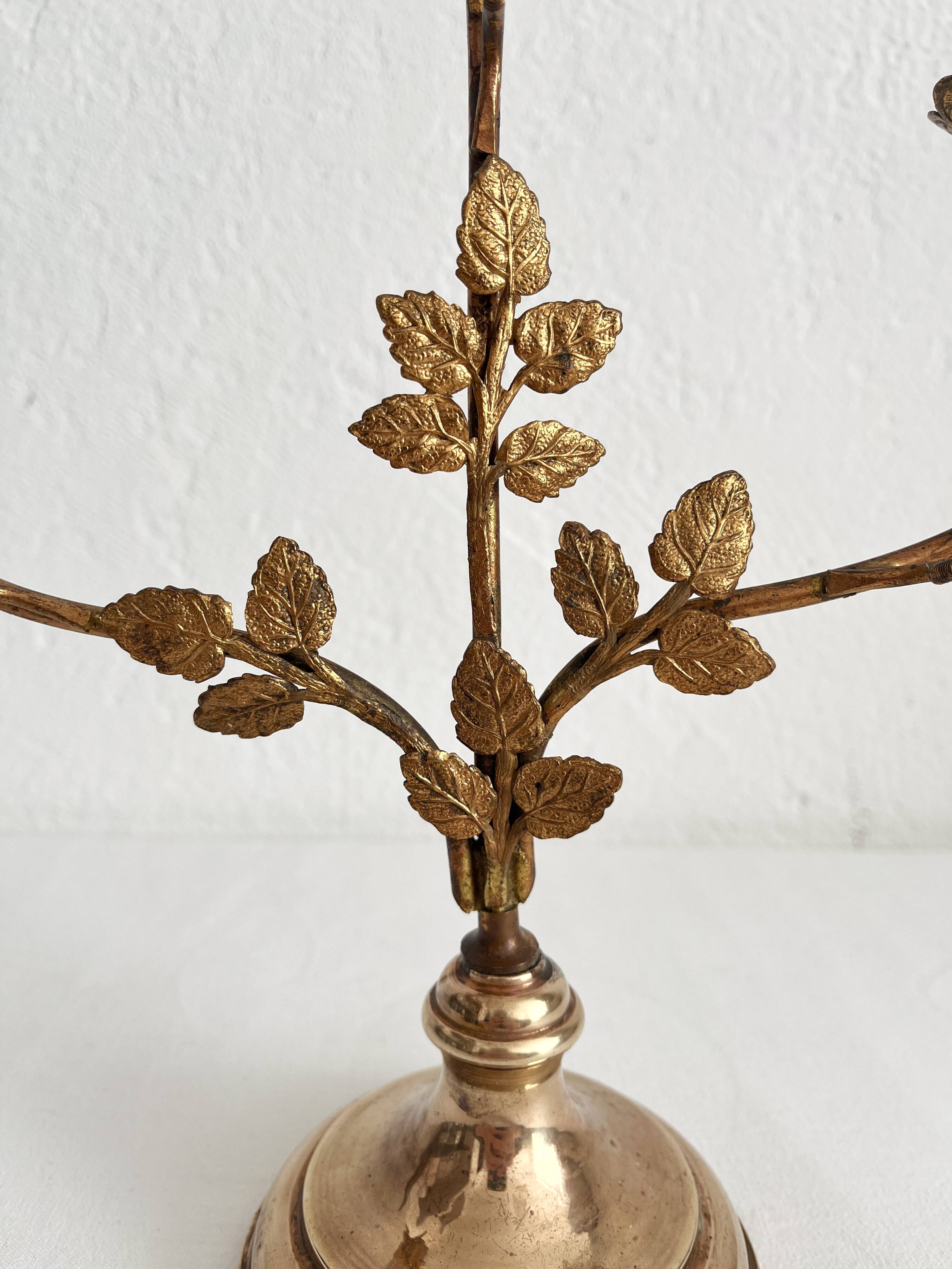 Antique bronze and brass candlestick with golden leaves